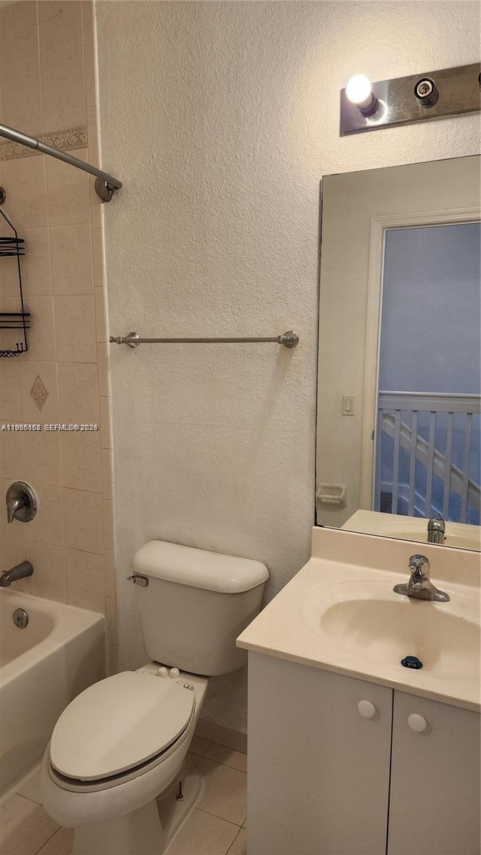 8450 Southwest 150th Avenue, Unit 3 Miami, FL 33193 - Photo 18 of 28 a bathroom with a sink a toilet a mirror and shower