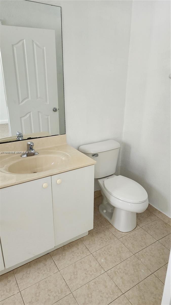 8450 Southwest 150th Avenue, Unit 3 Miami, FL 33193 - Photo 20 of 28 a bathroom with a sink a toilet and mirror