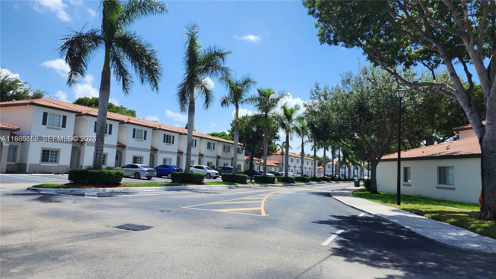 8450 Southwest 150th Avenue, Unit 3 Miami, FL 33193 - Photo 2 of 28 a city street lined with buildings and trees