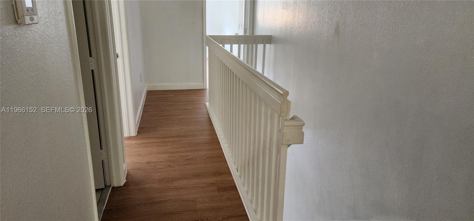 8450 Southwest 150th Avenue, Unit 3 Miami, FL 33193 - Photo 25 of 28 a view of a hallway with wooden floor and entryway