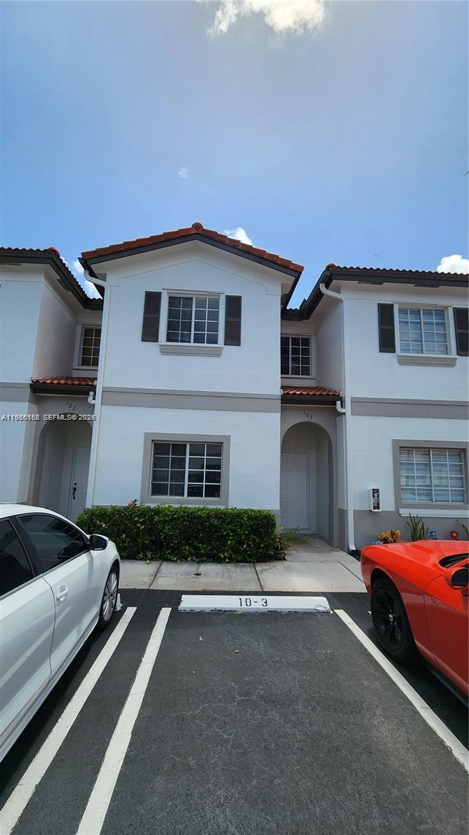 8450 Southwest 150th Avenue, Unit 3 Miami, FL 33193 - Photo 3 of 28 a car parked in front of white house