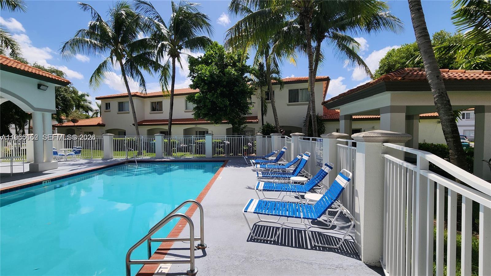 8450 Southwest 150th Avenue, Unit 3 Miami, FL 33193 - Photo 6 of 28 a view of a chair and tables in the patio in front of house