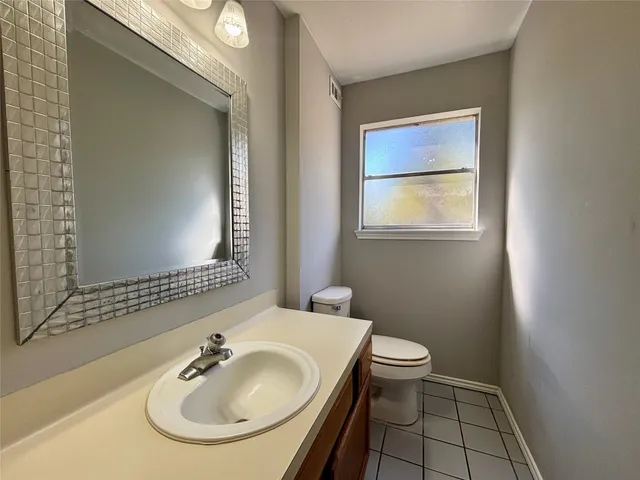 a bathroom with a sink a toilet and mirror