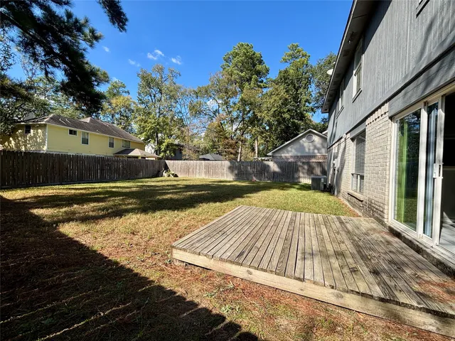 a view of backyard with large trees