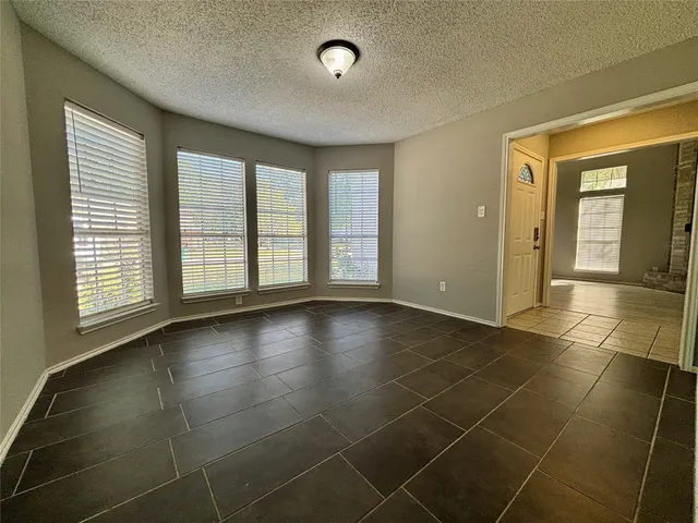 a view of a livingroom with wooden floor and a window