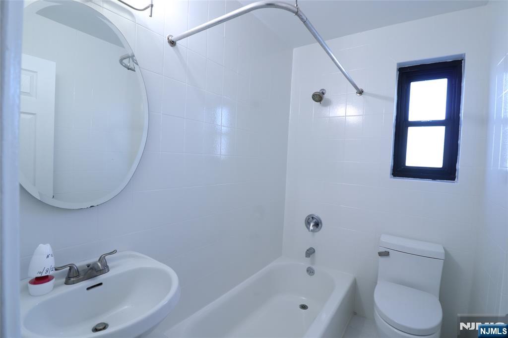 2335 Hudson Terrace, Unit E6 Fort Lee, NJ 07024 - Photo 15 of 29 a bathroom with a sink a toilet and bathtub