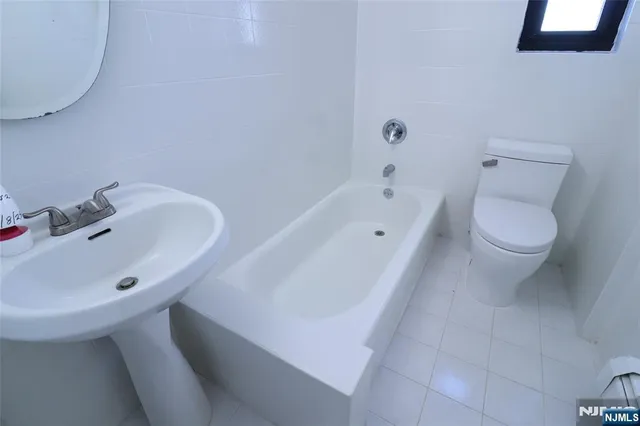 a bathroom with a sink a toilet and bathtub
