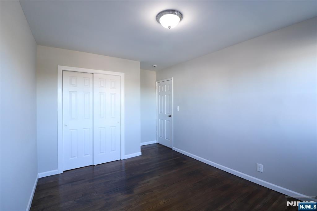 2335 Hudson Terrace, Unit E6 Fort Lee, NJ 07024 - Photo 20 of 29 an empty room with wooden floor and closet
