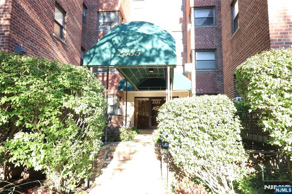 2335 Hudson Terrace, Unit E6 Fort Lee, NJ 07024 - Photo 2 of 29 a front view of a house with a garden