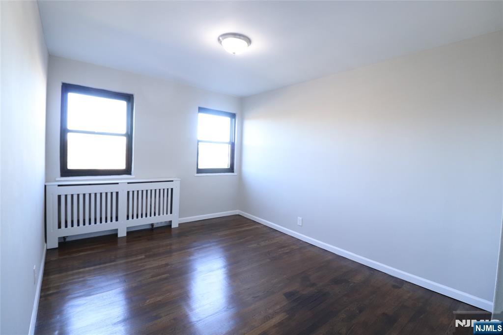 2335 Hudson Terrace, Unit E6 Fort Lee, NJ 07024 - Photo 23 of 29 an empty room with wooden floor and windows