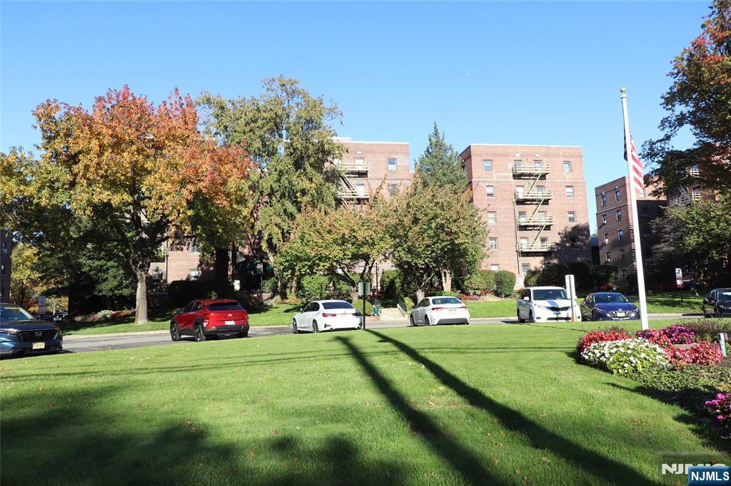 2335 Hudson Terrace, Unit E6 Fort Lee, NJ 07024 - Photo 26 of 29 a view of a park with large trees and cars parked