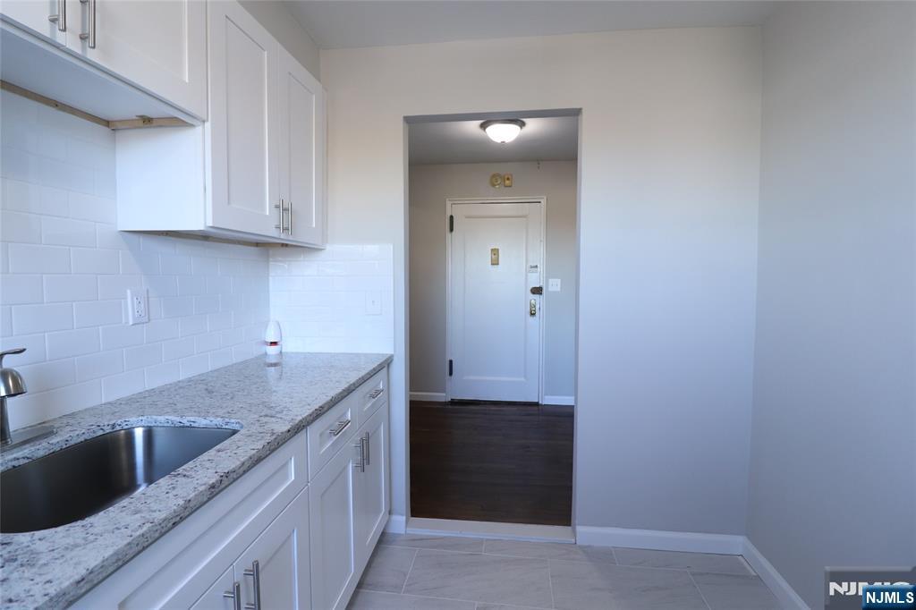 2335 Hudson Terrace, Unit E6 Fort Lee, NJ 07024 - Photo 10 of 29 a kitchen with a sink and cabinets