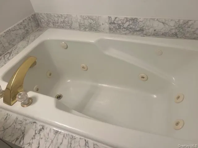 a bathroom with a granite countertop sink and shower