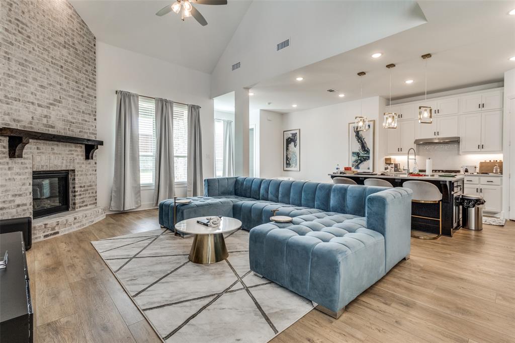 503 North Eagle Pt Road Van Alstyne, TX 75495 - Photo 2 of 25 Living room featuring high vaulted ceiling, light wood-style floors, a fireplace, a ceiling fan, and recessed lighting