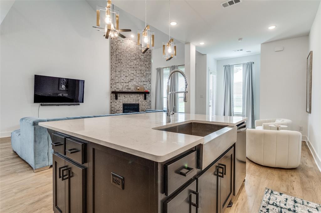 503 North Eagle Pt Road Van Alstyne, TX 75495 - Photo 25 of 25 Kitchen featuring open floor plan, dark brown cabinets, light wood-type flooring, and recessed lighting