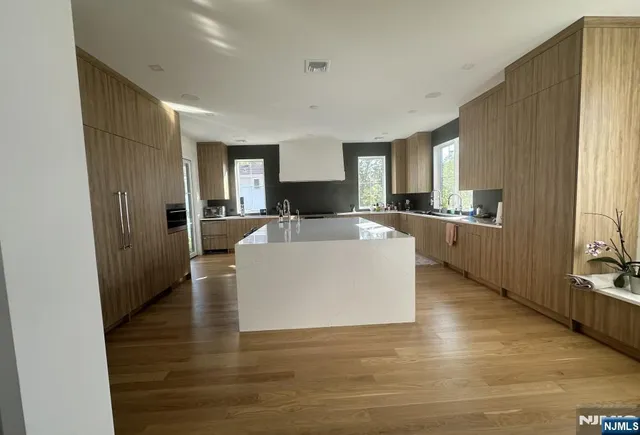 a view of a kitchen with cabinets and wooden floor