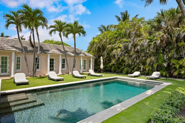 a view of swimming pool with a table and chairs