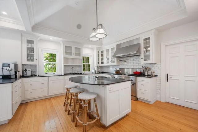 a kitchen with stainless steel appliances granite countertop a stove and a refrigerator