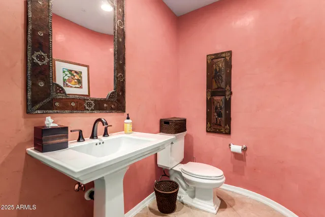 a bathroom with a sink mirror vanity and toilet