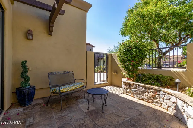 a bench sitting in backside of a house with wooden fence