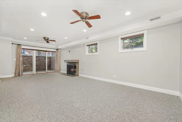 an empty room with furniture and a ceiling fan