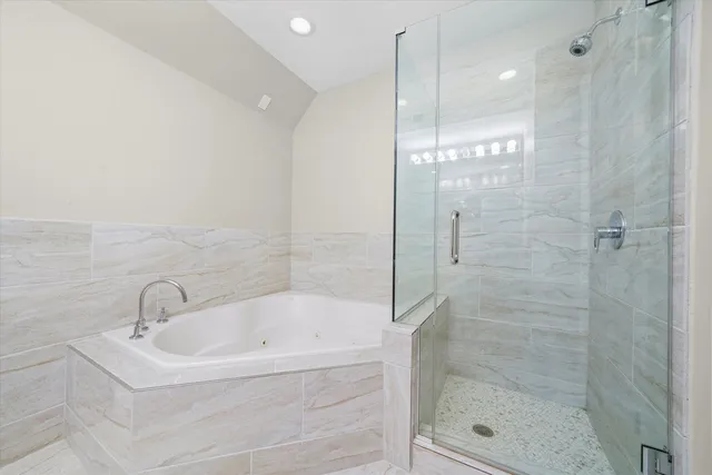 a white bath tub sitting next to a shower