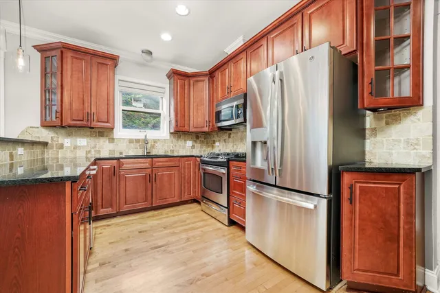 a kitchen with stainless steel appliances granite countertop a refrigerator sink and cabinets