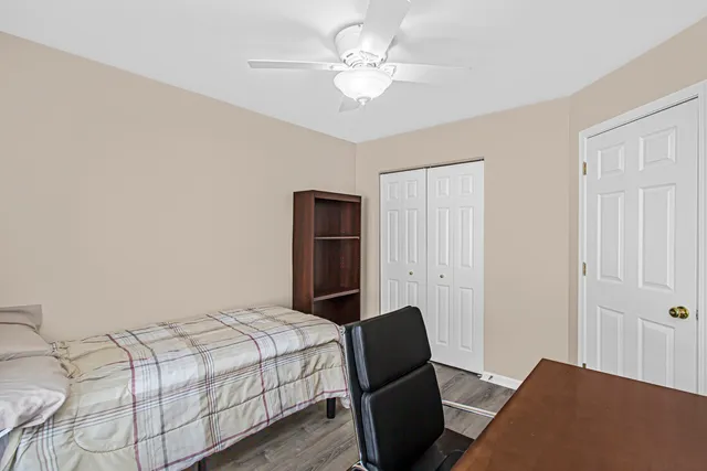 a bedroom with a large bed and a chandelier