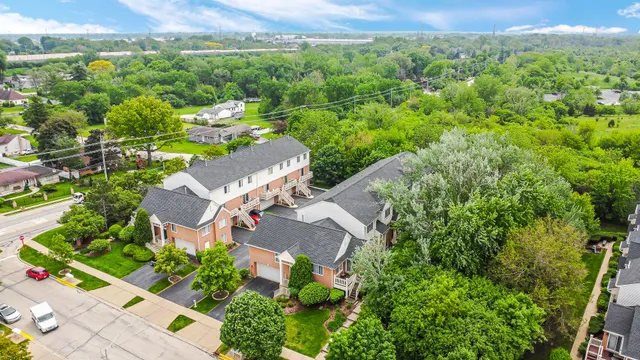 an aerial view of residential houses with outdoor space and street view