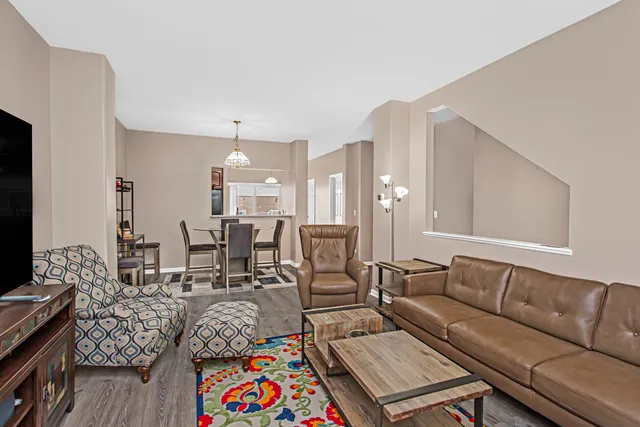 a living room with furniture and wooden floor