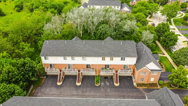 an aerial view of a house with a yard and garden
