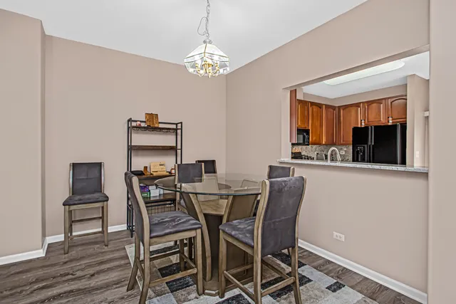 a view of a dining room with furniture and chandelier