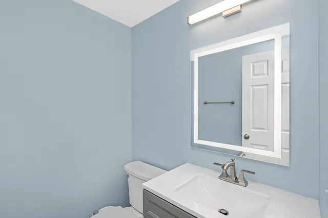 a bedroom with a bed flat screen tv and a window