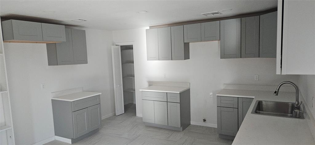2110 North 6th Street Waco, TX 76708 - Photo 17 of 23 a kitchen with a refrigerator sink and cabinets