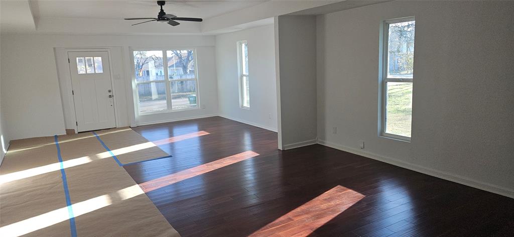 2110 North 6th Street Waco, TX 76708 - Photo 4 of 23 an empty room with wooden floor chandelier and windows