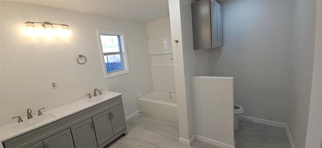 2110 North 6th Street Waco, TX 76708 - Photo 5 of 23 a bathroom with a tub sink toilet and mirror