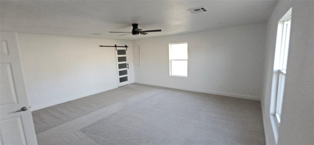 2110 North 6th Street Waco, TX 76708 - Photo 6 of 23 wooden floor in an empty room with a window