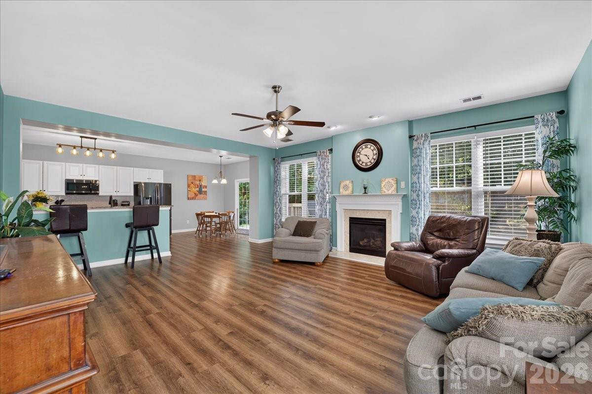 8006 Fine Robe Drive Indian Trail, NC 28079 - Photo 10 of 36 a living room with furniture a fireplace and a clock