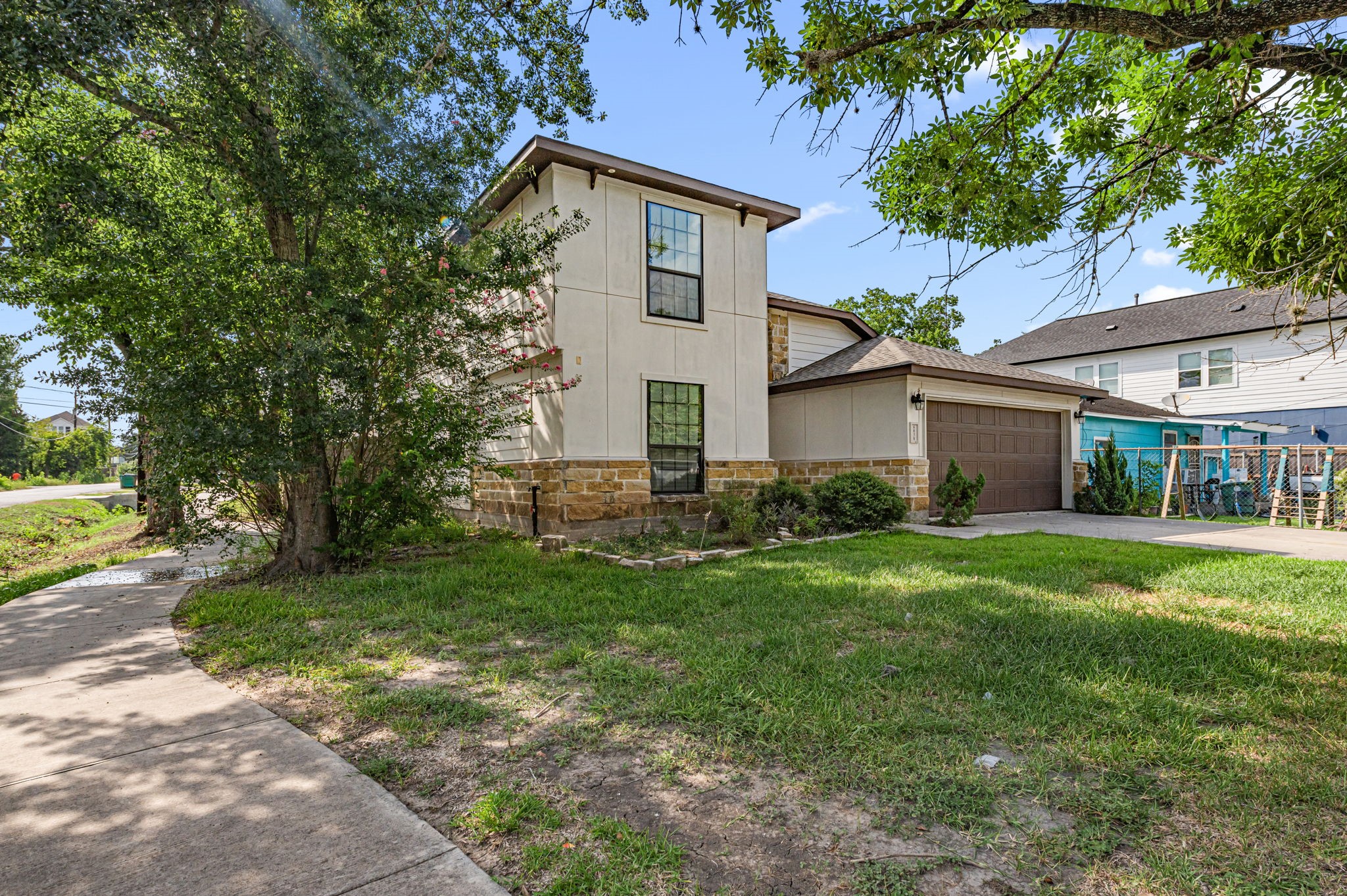 6838 Foster Street Houston, TX 77021 - Photo 3 of 24 Angled exterior view showcasing the home’s spacious front yard and established trees