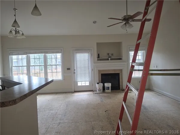 a living room with furniture and a fireplace