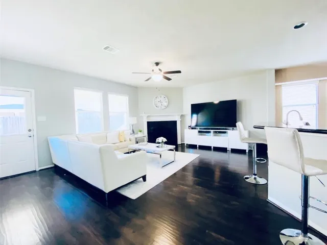 a living room with furniture and wooden floor