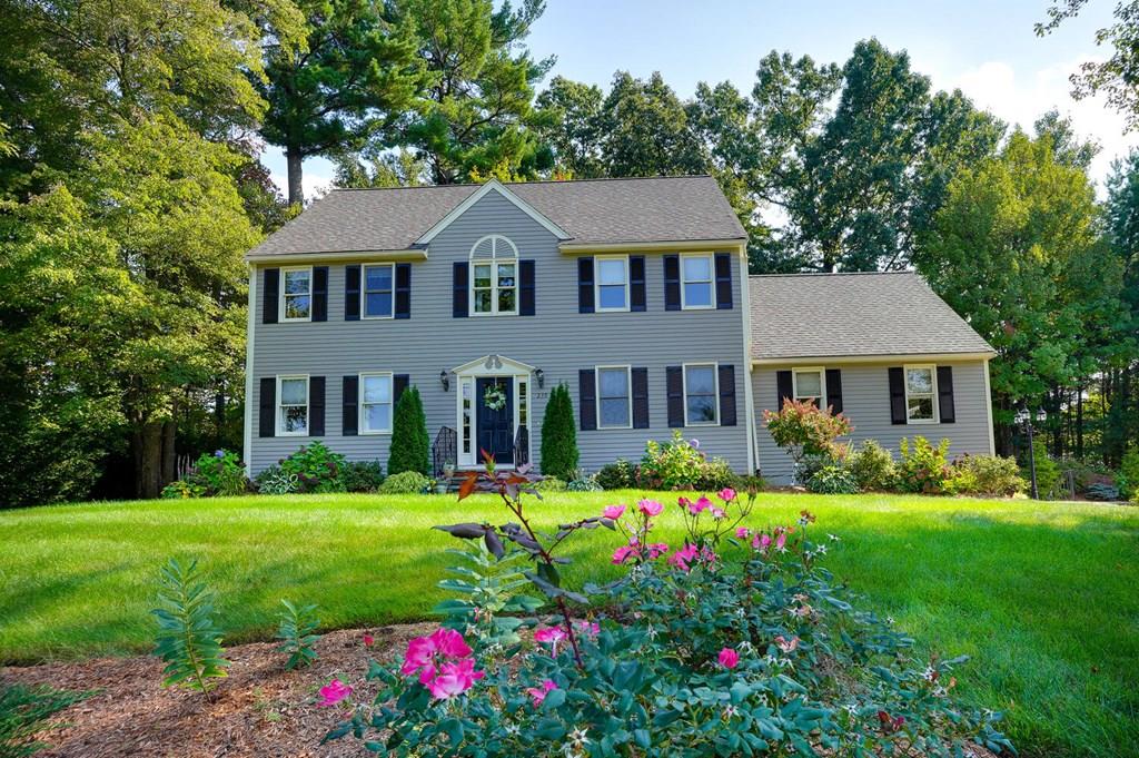 a front view of a house with a yard and porch