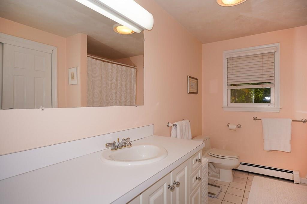 230 Simpson Road Marlborough, MA 01752 - Photo 25 of 32 a bathroom with a toilet a sink a mirror and a shower