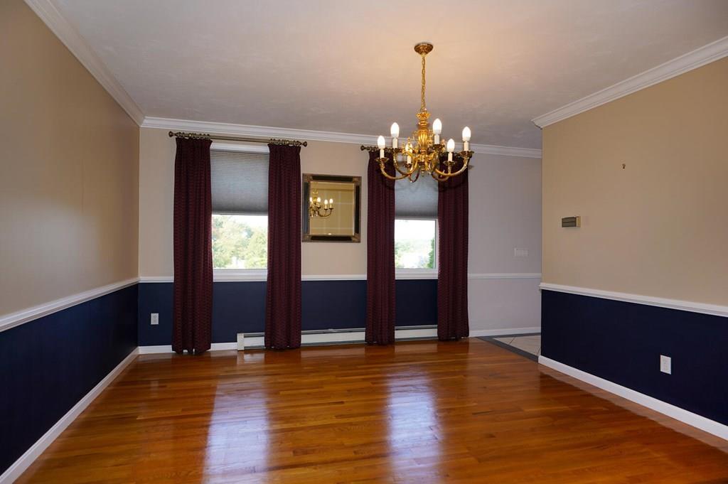 230 Simpson Road Marlborough, MA 01752 - Photo 10 of 32 a view of a livingroom with wooden floor and chandelier
