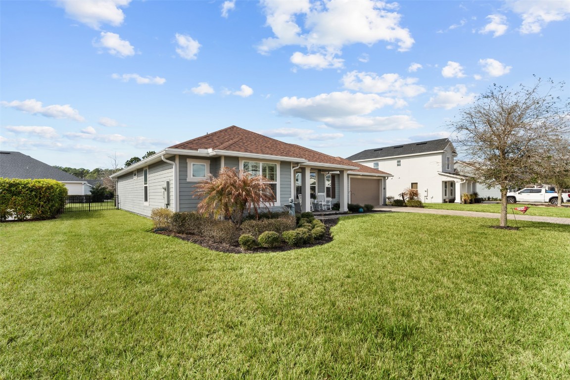 93322 Sandown Drive Fernandina Beach, FL 32034 - Photo 12 of 40 a view of a house with a big yard plants and large trees