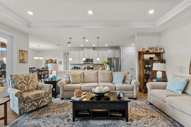 a living room with furniture and a view of kitchen
