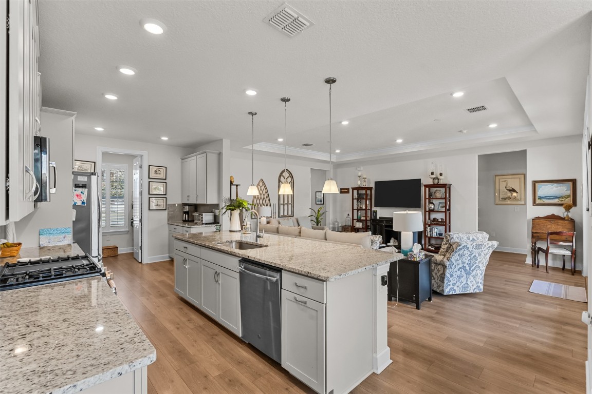 93322 Sandown Drive Fernandina Beach, FL 32034 - Photo 20 of 40 a large kitchen with stainless steel appliances kitchen island granite countertop a large island in the center
