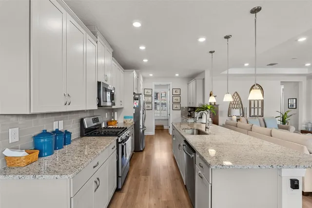 a kitchen with stainless steel appliances granite countertop sink stove and cabinets