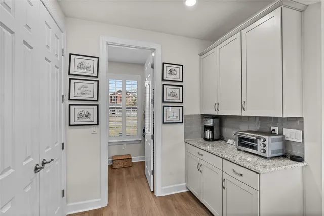 a kitchen with stainless steel appliances granite countertop a refrigerator and cabinets