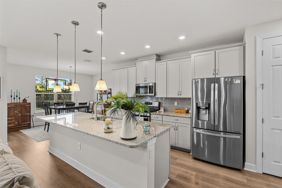 93322 Sandown Drive Fernandina Beach, FL 32034 - Photo 24 of 40 a kitchen with stainless steel appliances granite countertop a sink a stove and refrigerator